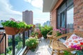 Beautiful balcony or terrace with chairs, natural material decorations and green potted flowers plants