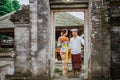 balinese couple going to pura to pray and make offering to the god