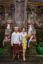 balinese couple going to pura to pray and make offering to the god