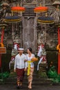 balinese couple going to pura to pray and make offering to the god