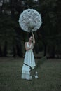 Beautiful ballerina with giant dandelions flowers