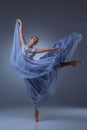 The beautiful ballerina dancing in blue long dress Royalty Free Stock Photo