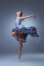 The beautiful ballerina dancing in blue long dress Royalty Free Stock Photo