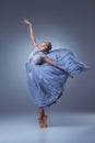 The beautiful ballerina dancing in blue long dress Royalty Free Stock Photo