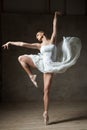 Beautiful ballerina dancing in white dress