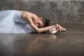 Beautiful ballerina doing the splits in white costume