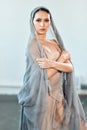 Beautiful ballerina wearing cape on head in stage grey loose transparent dress Royalty Free Stock Photo