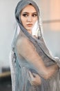 Beautiful ballerina wearing cape on head in stage grey loose transparent dress Royalty Free Stock Photo