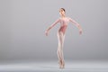 Beautiful ballerina on a white background. The ballerina is dressed in a light pink lace leotard, pink leotards, pointe shoes