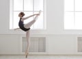 Beautiful ballerine stands in arabesque ballet position Royalty Free Stock Photo