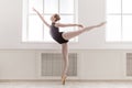 Beautiful ballerine stands in arabesque ballet position