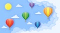 Beautiful balloons flying over fluffy clouds in the blue sky to the sun Royalty Free Stock Photo