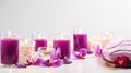 Beautiful banner with composition of towels, white burning candles, purple orchid flowers, grey stones on light Royalty Free Stock Photo