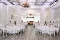 Beautiful banquet hall in the restaurant and elegant white tablecloths on tables Royalty Free Stock Photo