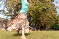 Beautiful barefoot girl in a long colorful skirt is dancing