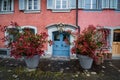 Beautiful baroque door in old house and two flowerpots with red leaf plants, Zug, Switzerland