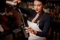 Girl transfusing drink from one steel cocktail shakers to another Royalty Free Stock Photo