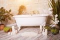 Beautiful bathroom with bath, flowers and candles at home Royalty Free Stock Photo
