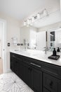 A beautiful bathroom with a black cabinet and pattern tile floor. Royalty Free Stock Photo