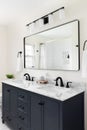 A bathroom with a blue cabinet and marble countertop. Royalty Free Stock Photo