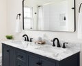 A bathroom detail with a blue cabinet and marble countertop. Royalty Free Stock Photo