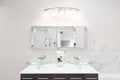 A modern bathroom with a wood cabinet and glass sink. Royalty Free Stock Photo