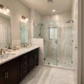 Beautiful bathroom in luxury home with double vanity bathtub and shower Features herringbone tile on floor and marble tile on