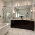 Beautiful bathroom in luxury home with double vanity bathtub and shower Features herringbone tile on floor and marble tile on Royalty Free Stock Photo