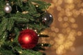 Beautiful baubles hanging on Christmas tree against blurred festive lights. Space for text Royalty Free Stock Photo