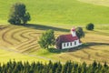 Beautiful chapel in lovely rural countryside. Pasture landscape with meadows and trees.