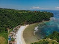 Beautiful bay beach with turquoise ocean water with many umbrellas top view aerial photo with white beach and jungle of tropical Royalty Free Stock Photo