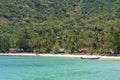 Beautiful bay with coconut palm trees and boats. Tropical sand beach and sea water on island Koh Phangan, Thailand Royalty Free Stock Photo