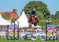 Horse jumping a fence at the Hanbury Countryside Show, England.