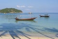 Beautiful bay with palm trees and boats. Tropical beach and sea water on the island Koh Phangan, Thailand Royalty Free Stock Photo