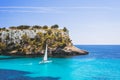 Beautiful bay with sailing boat yacht, Cala Galdana, Menorca island, Spain. Yachting, travel and active lifestyle concept