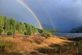 Double Rainbow over Upper Campbell Lake with Mountains of Strathcona Provincial Park, Vancouver Island, British Columbia Royalty Free Stock Photo