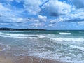 Beautiful beach with blue water and waves on cloudy sky background.Vacation landscape Royalty Free Stock Photo