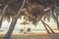 Beautiful beach. Chairs under palm trees sandy beach sea. Summer holiday and vacation concept for tourism. Inspirational beach Royalty Free Stock Photo