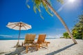 Beautiful beach. Chairs under palm trees sandy beach sea. Summer holiday and vacation concept for tourism. Inspirational beach Royalty Free Stock Photo