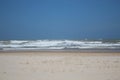 Beautiful beach with clear blue sky, waves and white sand Royalty Free Stock Photo