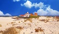 Beautiful beach coast landscape, sand dunes, colorful seaside boutique style vacation home cottage, blue summer sky - El Cotillo,