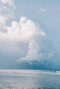 Beautiful beach day with large fluffy clouds and birds flying