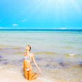 A beautiful beach with a kneeling girl Royalty Free Stock Photo