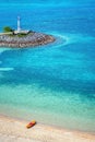 A beautiful beach in Okinawa, Japan with a boat on the shore. Seen from above, the white sand and clear turquoise and blue waters