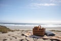 beautiful beach with picnic basket, blanket, and view of the ocean Royalty Free Stock Photo