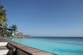 Beautiful beach resort bar at the Indian Ocean, amazing seascape with turquoise colors, palm trees and infinity pool Royalty Free Stock Photo