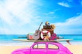 Vintage Retro beetle car with luggage and beach stuff on roof ready for summer vacation on beach in sunny Royalty Free Stock Photo