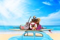 Vintage Retro beetle car with luggage and beach stuff on roof ready for summer vacation on beach in sunny Royalty Free Stock Photo