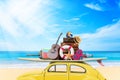 Vintage Retro beetle car with luggage and beach stuff on roof ready for summer vacation on beach in sunny Royalty Free Stock Photo