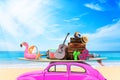 Vintage Retro beetle car with luggage and beach stuff on roof ready for summer vacation on beach in sunny Royalty Free Stock Photo